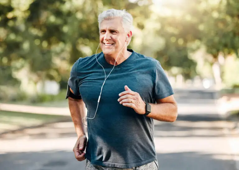 Elderly man running with headphones in
