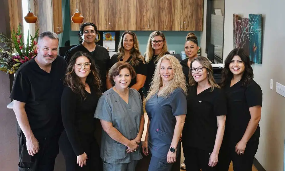 Members of the Home Dialysis Therapies of San Diego care team standing together inside the North San Diego clinic.