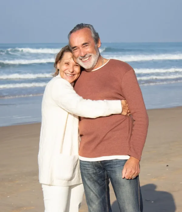 older-couple-hugging-beach